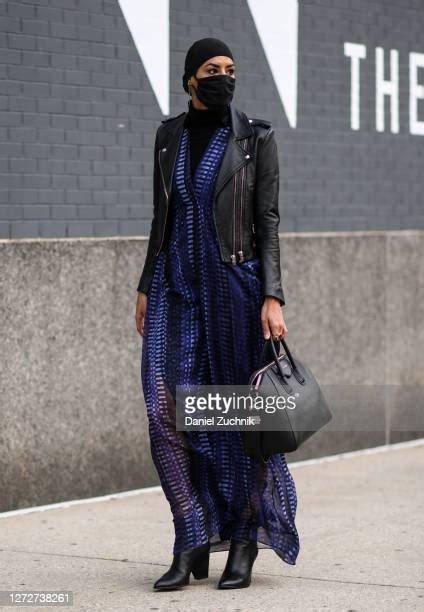 Model Eman B Fendi is seen wearing a black jacket, blue dress 